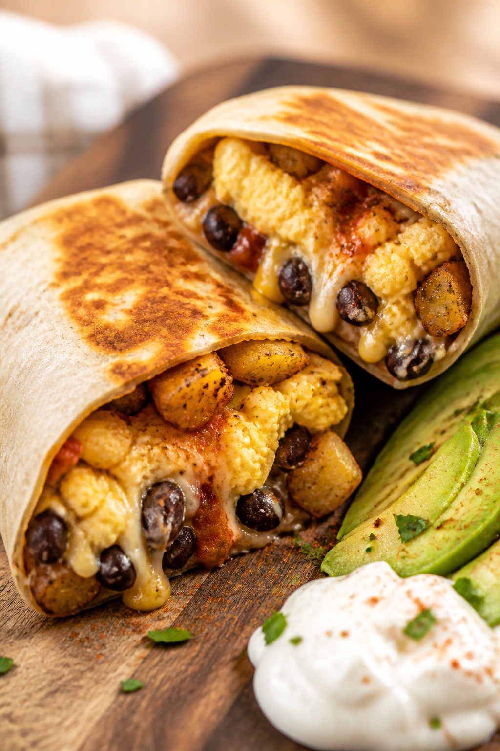 Close-up detail: A just-toasted Mexican breakfast burrito sliced on the diagonal, showing fluffy sof